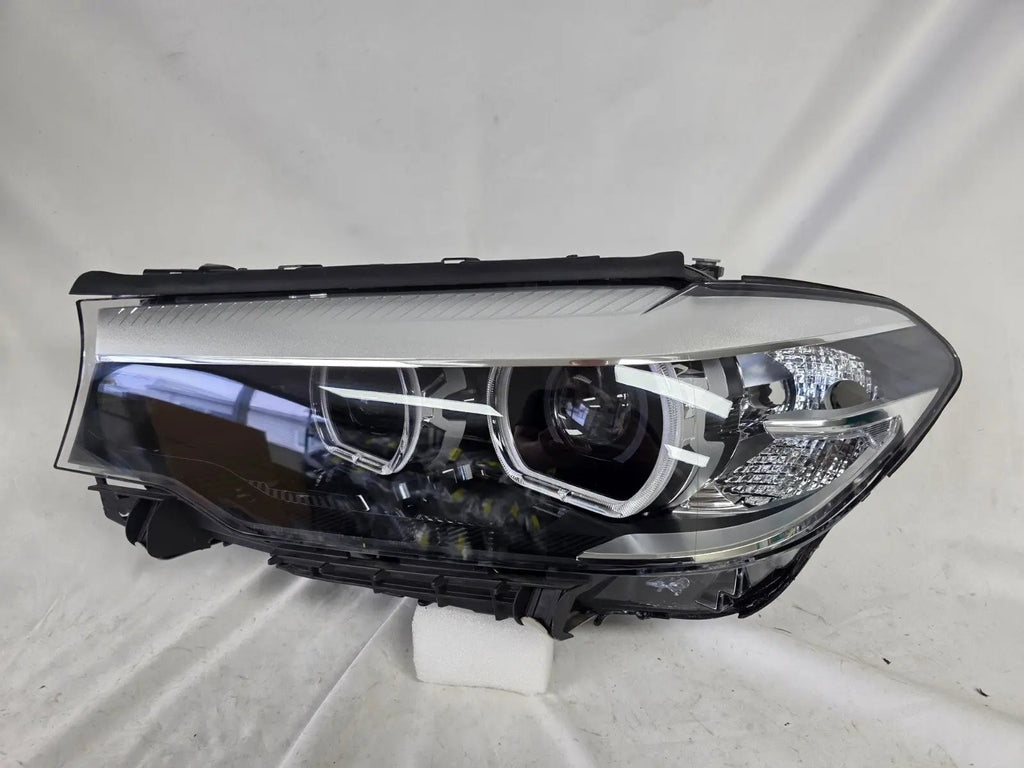 This image shows the left-side LED headlight for the BMW 5 Series G30 and G31 models, featuring OEM genuine quality with part number 7439199. This used original headlamp is engineered for a precise fit on the left side, offering bright and efficient LED illumination, modern styling, and the reliable performance expected from BMW components.