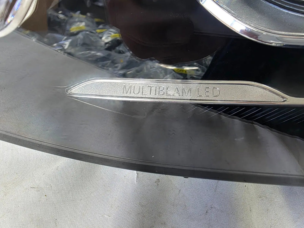 This image displays the left-side Multibeam LED headlight with blue accents for the Mercedes-Benz E-Class W213, featuring OEM genuine quality and part number A2139066504. This original used headlamp is designed for precise fitment on the W213 model, offering advanced Multibeam LED technology with distinctive blue detailing for high-performance adaptive illumination and premium styling