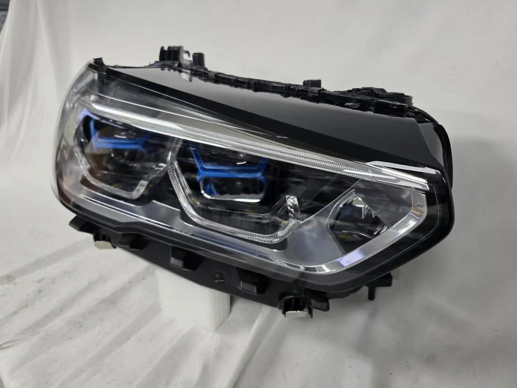 This image displays the right-side Laser headlight for BMW models X5 G05, X5 M F95, X6 G06, and X6 M F96, featuring OEM genuine quality with part number 5A27998. This used original headlamp delivers cutting-edge BMW Laserlight technology, offering enhanced night visibility, precise fitment, and a sleek, high-performance design tailored for these luxury SUV models.