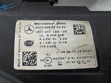 Load image into Gallery viewer, This image displays the left-side Multibeam LED headlight with blue accents for the Mercedes-Benz E-Class W213, featuring OEM genuine quality and part number A2139066504. This original used headlamp is designed for precise fitment on the W213 model, offering advanced Multibeam LED technology with distinctive blue detailing for high-performance adaptive illumination and premium styling