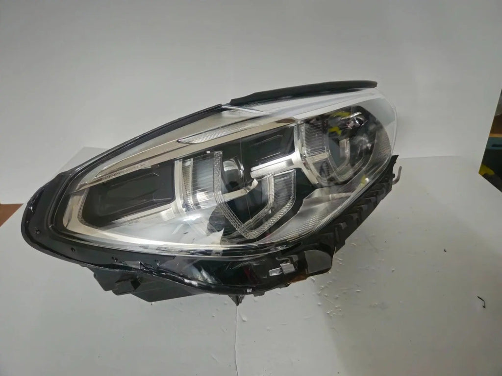 This image displays the right-side ICON Adaptive LED headlight for BMW models iX3 G08, X3 G01, X3 M F97, X4 G02, and X4 M F98, featuring OEM genuine quality with part number 7494052. This used original headlamp offers BMW’s advanced Adaptive LED with ICON design, delivering precise light distribution, dynamic styling, and perfect fitment for these specific models