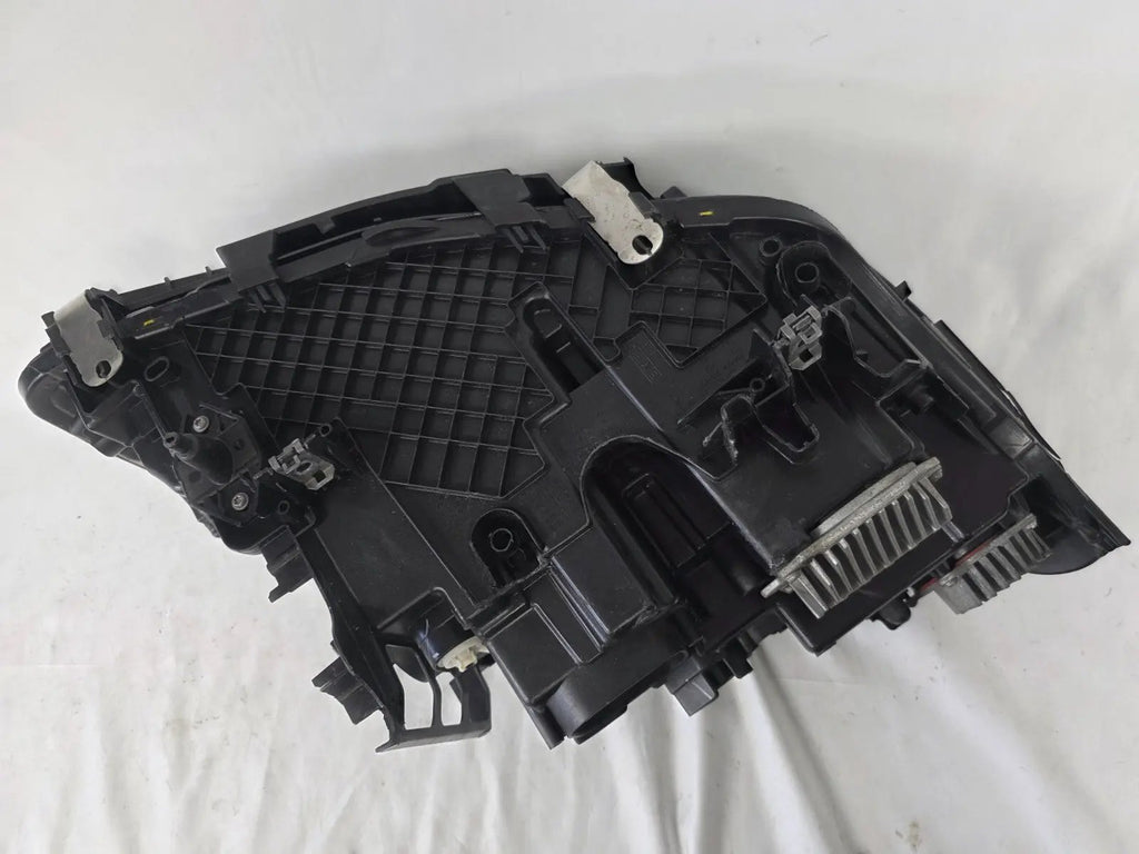 Genuine OEM BMW Laser headlight for 5 Series models G30, G31, and F90 LCI (facelift). This left-side headlamp, part number 5A388D5, is equipped with advanced laser lighting technology for superior visibility and precision on the road. The image displays the original left laser headlight in used condition, clearly showing the lens structure, cooling fins, mounting points, and connector ports — ideal for OEM replacement on compatible BMW 5 Series LCI vehicles.