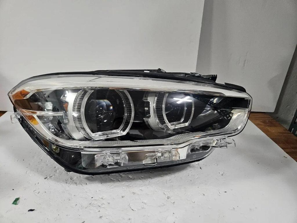 This image displays the right-side LED headlight for the BMW 1 Series F20 and F21 LCI (facelift) models, featuring OEM genuine quality with part number 7414142. This used original headlamp is engineered for a precise fit on the facelifted 1 Series, offering bright LED illumination, modern styling, and reliable performance from an authentic BMW component