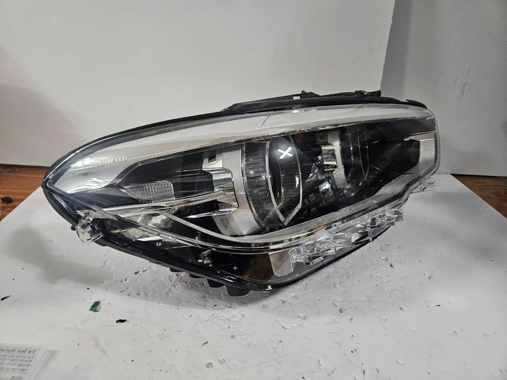 This image displays the right-side LED headlight for the BMW 1 Series F20 and F21 LCI (facelift) models, featuring OEM genuine quality with part number 7414142. This used original headlamp is engineered for a precise fit on the facelifted 1 Series, offering bright LED illumination, modern styling, and reliable performance from an authentic BMW component