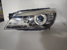 Load image into Gallery viewer, This image features the left-side Xenon headlight for the BMW 7 Series F01/F02 models, showcasing used OEM genuine quality with part number 7225229. Designed specifically for the F01 and F02 chassis, this original headlamp offers high-intensity Xenon lighting and precise fitment for the left side, ensuring reliable performance and compatibility.