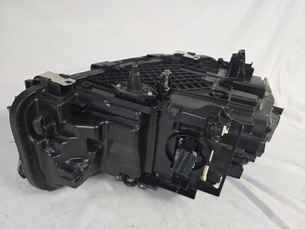 Genuine OEM BMW Laser headlight for 5 Series models G30, G31, and F90 LCI (facelift). This left-side headlamp, part number 5A388D5, is equipped with advanced laser lighting technology for superior visibility and precision on the road. The image displays the original left laser headlight in used condition, clearly showing the lens structure, cooling fins, mounting points, and connector ports — ideal for OEM replacement on compatible BMW 5 Series LCI vehicles.