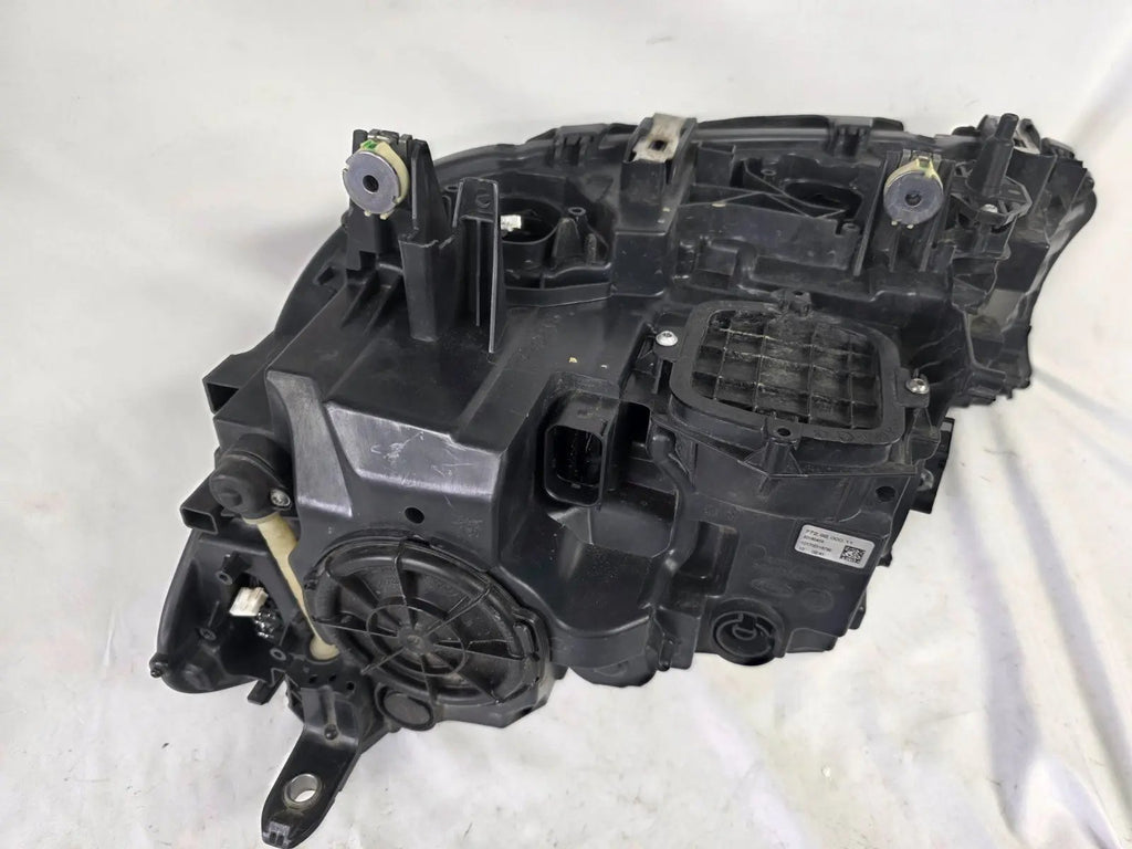 Used genuine BMW Laser headlight for 7 Series models G11 and G12. This right-side OEM headlamp, part number 7465606, features advanced laser lighting technology for superior visibility and performance. The image shows the original BMW right laser headlight in used condition, highlighting the detailed lens design, housing structure, and connector ports — ideal for high-end replacement or repair on compatible 7 Series vehicles.