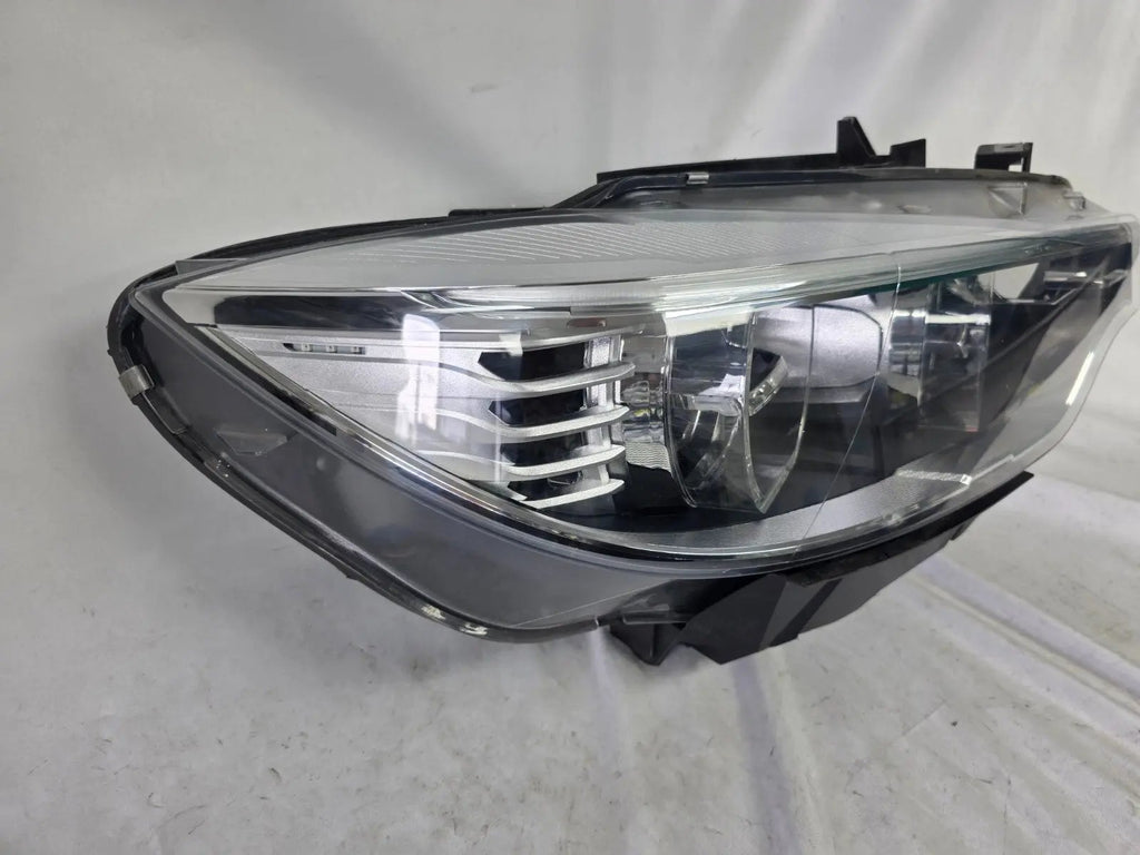 Genuine used BMW Adaptive LED headlight for 4 Series models F32, F33, F36, F80 LCI, F82, and F83. This right-side OEM headlamp, part number 7377842, is designed with adaptive lighting technology for improved visibility and performance. The image highlights the complete original headlight unit in used condition, including the clear lens, mounting points, and electrical connectors — ideal for replacement on compatible BMW models.
