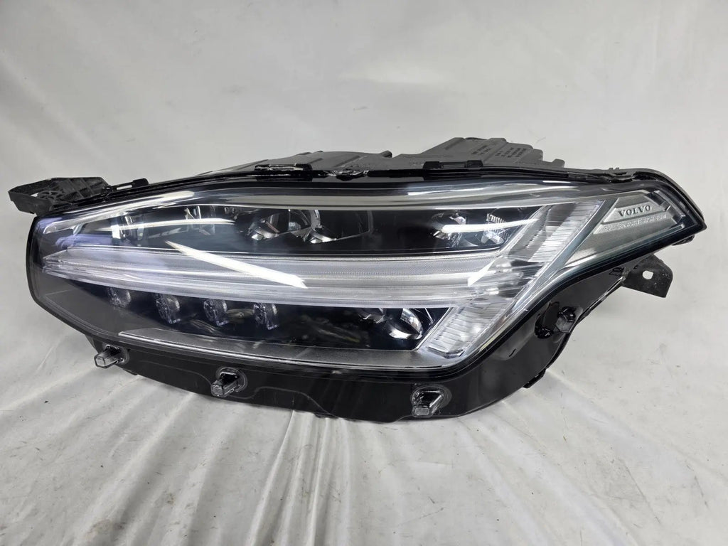 This image features the left-side Xenon headlight for the Volvo XC90, showcasing OEM genuine quality with part number 32404715. This used original headlamp is designed for accurate fitment and delivers powerful Xenon illumination, ensuring optimal visibility, durability, and premium performance for the XC90 luxury SUV