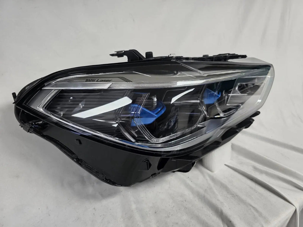 This image displays the right-side Laser headlight for BMW models X5 G05, X5 M F95, X6 G06, and X6 M F96, featuring OEM genuine quality with part number 5A27998. This used original headlamp delivers cutting-edge BMW Laserlight technology, offering enhanced night visibility, precise fitment, and a sleek, high-performance design tailored for these luxury SUV models.