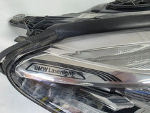 Load image into Gallery viewer, Used genuine BMW Laser headlight for 7 Series models G11 and G12. This right-side OEM headlamp, part number 7465606, features advanced laser lighting technology for superior visibility and performance. The image shows the original BMW right laser headlight in used condition, highlighting the detailed lens design, housing structure, and connector ports — ideal for high-end replacement or repair on compatible 7 Series vehicles.
