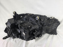Load image into Gallery viewer, Used genuine BMW Laser headlight for 7 Series models G11 and G12. This right-side OEM headlamp, part number 7465606, features advanced laser lighting technology for superior visibility and performance. The image shows the original BMW right laser headlight in used condition, highlighting the detailed lens design, housing structure, and connector ports — ideal for high-end replacement or repair on compatible 7 Series vehicles.

