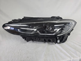 Used genuine BMW LED headlight for 4 Series models including G22, G23, G26, G80, G82, and G83. This left-side OEM headlamp, part number 9851035, is designed to perfectly fit and function in compatible BMW vehicles. The image shows the original BMW LED headlight in used condition with visible connectors, housing, and lens – ideal for replacement or repair of your vehicle’s front lighting system.