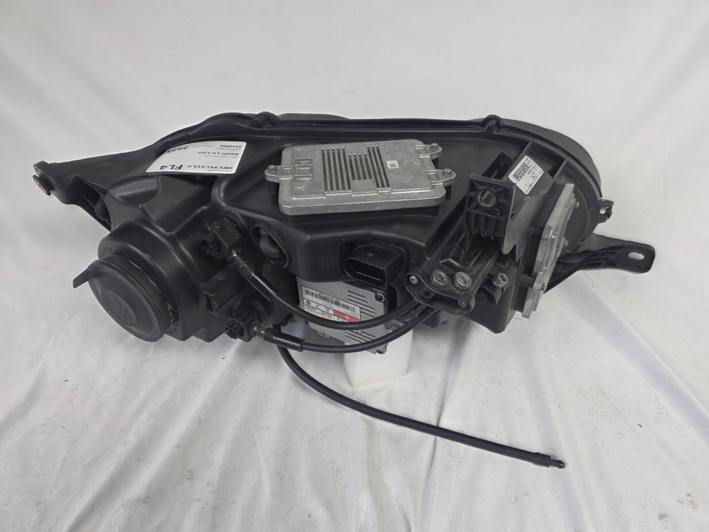 This image shows the left-side headlight for the 2014–2019 Bentley Flying Spur, featuring OEM genuine quality with part number 4W1941015H. This used original headlamp is in excellent condition, offering premium illumination, elegant design, and a precise fit for Bentley’s high-end luxury sedan