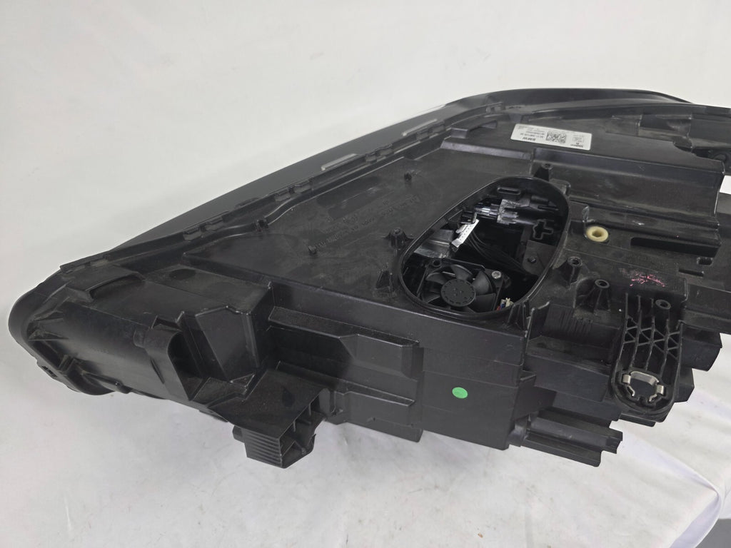 Used genuine BMW Adaptive LED headlight for X1 F48 LCI (facelift) model. This right-side OEM headlamp, part number 5A01178, is equipped with adaptive lighting technology for improved night visibility and cornering performance. The image displays the original right Adaptive LED headlight in used condition, showing the clear lens, mounting brackets, and electrical connectors — an ideal OEM replacement for BMW X1 F48 LCI vehicles.

