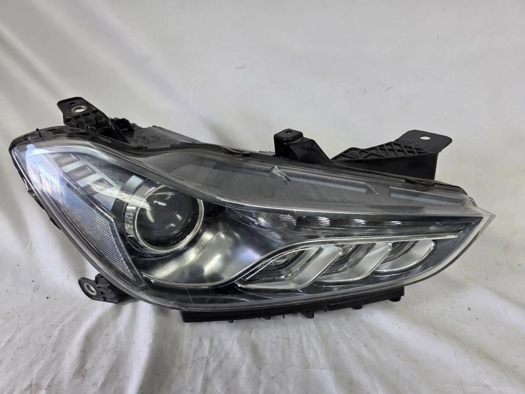 This image shows the right-side Xenon headlight for the Maserati Ghibli models from 2014 to 2017, featuring OEM genuine quality with part number 00670004658. This used original headlamp is designed for perfect fitment, delivering powerful Xenon lighting and the signature sleek styling expected from Maserati’s luxury performance vehicles
