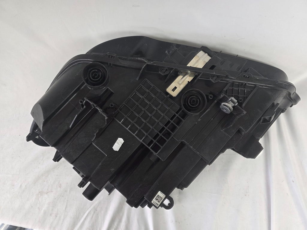 Used genuine BMW Adaptive LED headlight for X1 F48 LCI (facelift) model. This right-side OEM headlamp, part number 5A01178, is equipped with adaptive lighting technology for improved night visibility and cornering performance. The image displays the original right Adaptive LED headlight in used condition, showing the clear lens, mounting brackets, and electrical connectors — an ideal OEM replacement for BMW X1 F48 LCI vehicles.

