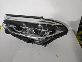 This image shows the left-side Adaptive LED ICON headlight for the BMW 5 Series G30, G31, G38, and F90 LCI models, featuring OEM genuine quality with part number 8499121. This used original headlamp is designed for the facelifted (LCI) versions of these models, offering BMW’s signature Adaptive LED ICON lighting technology for enhanced visibility, precise beam control, and a sleek, modern design.