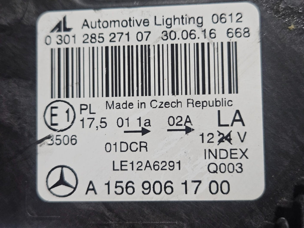 Genuine used Mercedes-Benz Bi-Xenon headlight for GLA-Class model X156. This left-side (LH) OEM headlamp, part number A1569061700, features Bi-Xenon lighting technology for enhanced night visibility and a focused beam pattern. The image shows the original left headlight in used condition, highlighting the lens clarity, projector unit, mounting brackets, and electrical connector — ideal for replacing a damaged headlamp on compatible Mercedes-Benz GLA X156 vehicles.