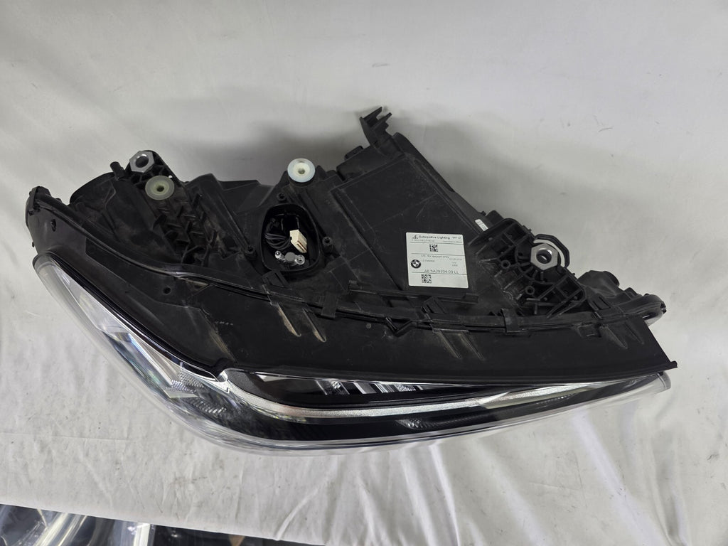 Genuine OEM Adaptive LED headlight for BMW iX3 and compatible models including G08, G01, F97, G02, and F98 with LCI (facelift) updates. This right-side headlamp, part number 5A29204, features adaptive lighting technology for enhanced road illumination and driving safety. The image showcases the original right LED headlight in used condition, clearly showing the lens, housing, and connector points — perfect for replacement on BMW iX3 and related LCI models.