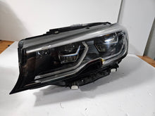 Load image into Gallery viewer, Genuine used BMW Laser headlight for 3 Series models G20 and G21. This left-side OEM headlamp, part number 9481707, features high-performance laser lighting technology for superior road visibility and driving precision. The image showcases the original left laser headlight in used condition, clearly showing the lens structure, housing, and connector ports — ideal for replacing a damaged headlamp on compatible BMW 3 Series vehicles.

