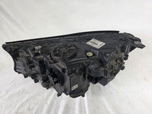 Load image into Gallery viewer, Used genuine BMW Laser headlight for 7 Series models G11 and G12. This right-side OEM headlamp, part number 7465606, features advanced laser lighting technology for superior visibility and performance. The image shows the original BMW right laser headlight in used condition, highlighting the detailed lens design, housing structure, and connector ports — ideal for high-end replacement or repair on compatible 7 Series vehicles.

