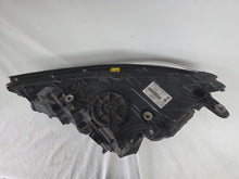 Load image into Gallery viewer, Used genuine BMW Laser headlight for 7 Series models G11 and G12. This right-side OEM headlamp, part number 7465606, features advanced laser lighting technology for superior visibility and performance. The image shows the original BMW right laser headlight in used condition, highlighting the detailed lens design, housing structure, and connector ports — ideal for high-end replacement or repair on compatible 7 Series vehicles.

