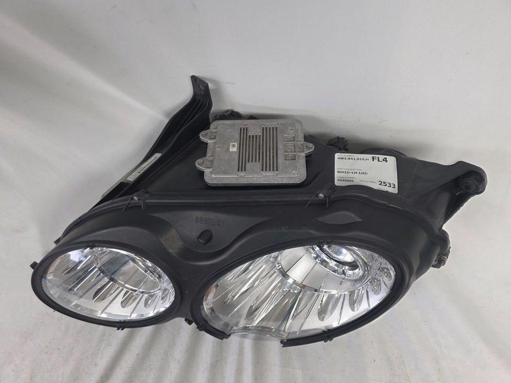 This image shows the left-side headlight for the 2014–2019 Bentley Flying Spur, featuring OEM genuine quality with part number 4W1941015H. This used original headlamp is in excellent condition, offering premium illumination, elegant design, and a precise fit for Bentley’s high-end luxury sedan