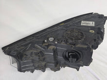 Load image into Gallery viewer, Used genuine BMW Laser headlight for 7 Series models G11 and G12. This right-side OEM headlamp, part number 7465606, features advanced laser lighting technology for superior visibility and performance. The image shows the original BMW right laser headlight in used condition, highlighting the detailed lens design, housing structure, and connector ports — ideal for high-end replacement or repair on compatible 7 Series vehicles.