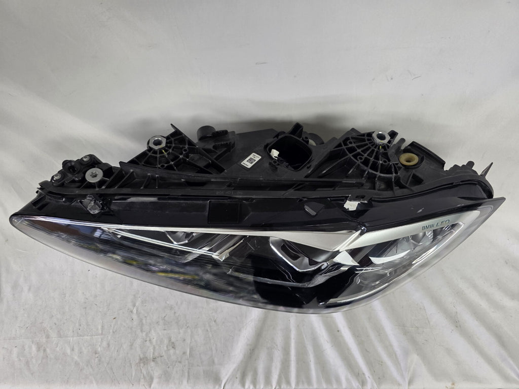 Used genuine BMW LED headlight for 4 Series models including G22, G23, G26, G80, G82, and G83. This left-side OEM headlamp, part number 9851035, is designed to perfectly fit and function in compatible BMW vehicles. The image shows the original BMW LED headlight in used condition with visible connectors, housing, and lens – ideal for replacement or repair of your vehicle’s front lighting system.

