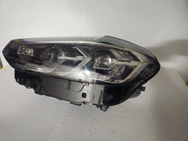 This image features the left-side Adaptive LED headlight for BMW models including iX3 G08, X3 G01, X3 M F97, X4 G02, and X4 M F98, with OEM genuine quality and part number 5A29203. This used original headlamp provides precise fitment and BMW’s advanced Adaptive LED technology, ensuring enhanced visibility, dynamic beam control, and premium styling for these performance SUVs.