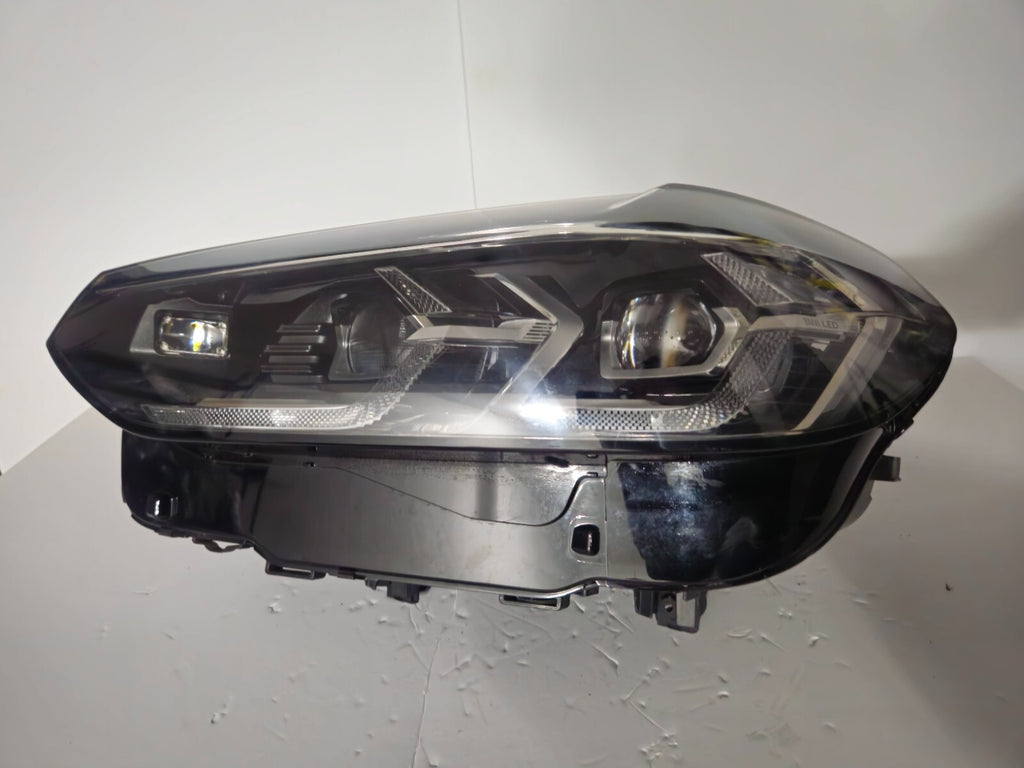 This image features the left-side Adaptive LED headlight for BMW models including iX3 G08, X3 G01, X3 M F97, X4 G02, and X4 M F98, with OEM genuine quality and part number 5A29203. This used original headlamp provides precise fitment and BMW’s advanced Adaptive LED technology, ensuring enhanced visibility, dynamic beam control, and premium styling for these performance SUVs.