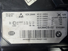 Load image into Gallery viewer, Genuine OEM BMW Laser headlight for 5 Series models G30, G31, and F90 LCI (facelift). This left-side headlamp, part number 5A388D5, is equipped with advanced laser lighting technology for superior visibility and precision on the road. The image displays the original left laser headlight in used condition, clearly showing the lens structure, cooling fins, mounting points, and connector ports — ideal for OEM replacement on compatible BMW 5 Series LCI vehicles.

