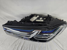 Load image into Gallery viewer, Genuine OEM BMW Laser headlight for 5 Series models G30, G31, and F90 LCI (facelift). This left-side headlamp, part number 5A388D5, is equipped with advanced laser lighting technology for superior visibility and precision on the road. The image displays the original left laser headlight in used condition, clearly showing the lens structure, cooling fins, mounting points, and connector ports — ideal for OEM replacement on compatible BMW 5 Series LCI vehicles.

