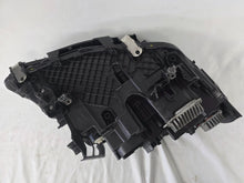 Load image into Gallery viewer, Genuine OEM BMW Laser headlight for 5 Series models G30, G31, and F90 LCI (facelift). This left-side headlamp, part number 5A388D5, is equipped with advanced laser lighting technology for superior visibility and precision on the road. The image displays the original left laser headlight in used condition, clearly showing the lens structure, cooling fins, mounting points, and connector ports — ideal for OEM replacement on compatible BMW 5 Series LCI vehicles.

