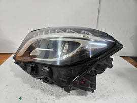 Genuine used Mercedes-Benz Bi-Xenon headlight for GLA-Class model X156. This left-side (LH) OEM headlamp, part number A1569061700, features Bi-Xenon lighting technology for enhanced night visibility and a focused beam pattern. The image shows the original left headlight in used condition, highlighting the lens clarity, projector unit, mounting brackets, and electrical connector — ideal for replacing a damaged headlamp on compatible Mercedes-Benz GLA X156 vehicles.
